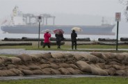 Sandbags are placed along the shores of Locarno Beach in Vancouver, Wednesday Dec. 10, 2014. Severe rains along with a rare king tide are threatening homes in low-lying areas. THE CANADIAN PRESS/Jonathan Hayward